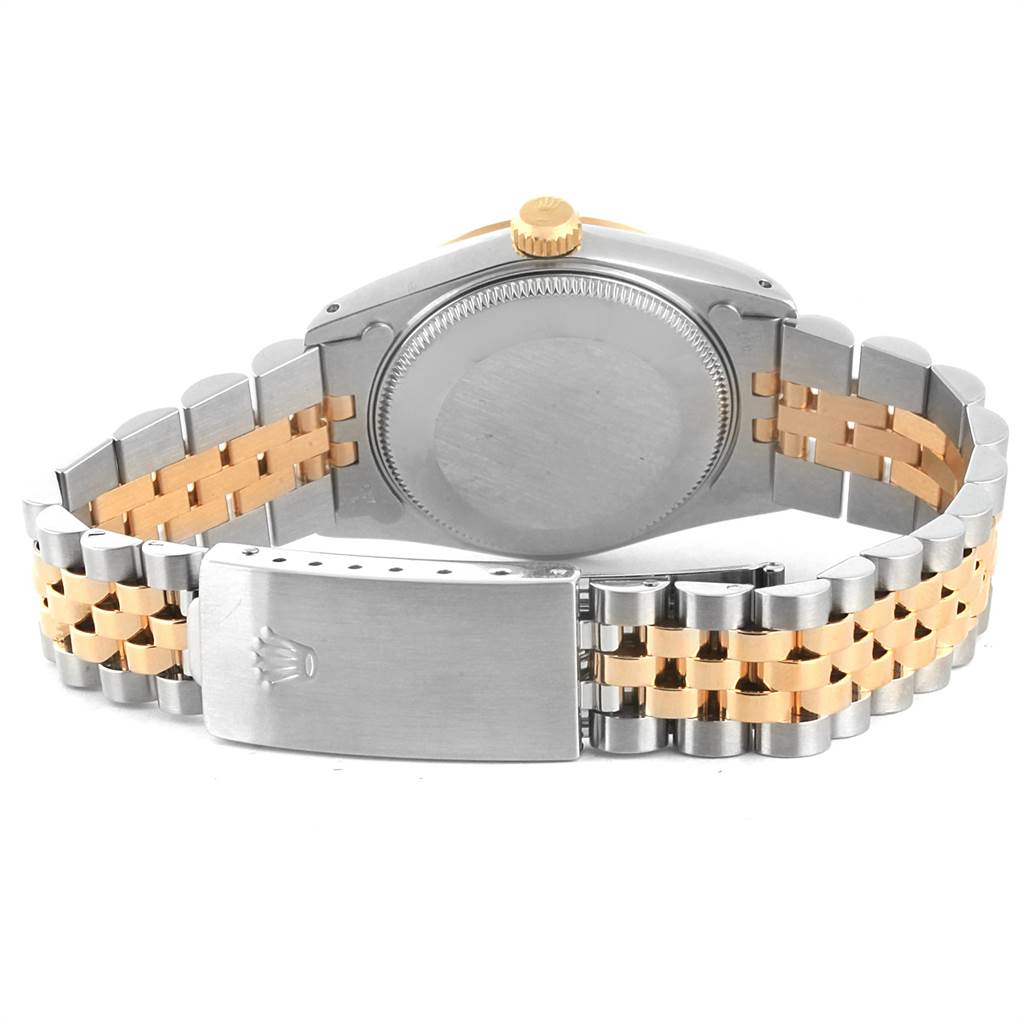 The image shows the back view of a Rolex Mid-Size 68273 Women's Steel and Gold (two tone) Champagne Dial 68273 Women's Steel and Gold (two tone) Champagne Dial watch, highlighting its case back and bi-metal bracelet with a clasp.