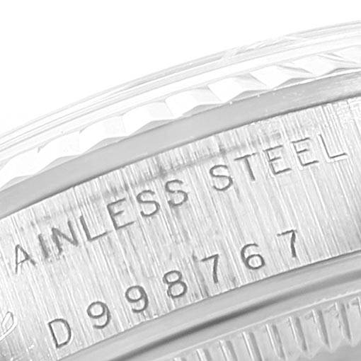 The image shows a close-up of the serial number and "STAINLESS STEEL" engraving on the bezel of a Mid-Size Rolex watch.