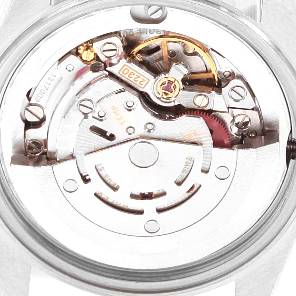 The image shows the internal mechanism of a Rolex Mid-Size 77014 Women's Stainless Steel Silver Dial 77014 Women's Stainless Steel Silver Dial model watch, viewed from the case back angle.