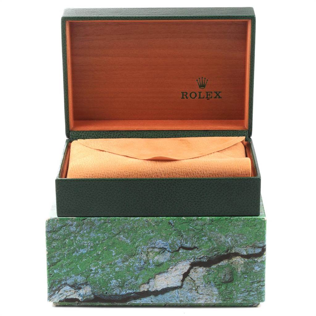 The image shows a green Rolex watch box with an orange leather pouch inside and the Rolex logo visible on the interior of the box lid.