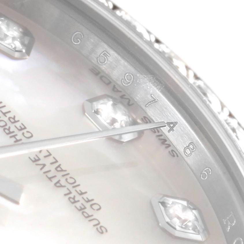 This close-up angle shows the dial of a Rolex Mid-Size 178384 Women's Stainless Steel Mother of Pearl Dial 178384 Women's Stainless Steel Mother of Pearl Dial watch, including the hands, numbers, and part of the text "SUPERLATIVE OFFICIALLY CERTIFIED."