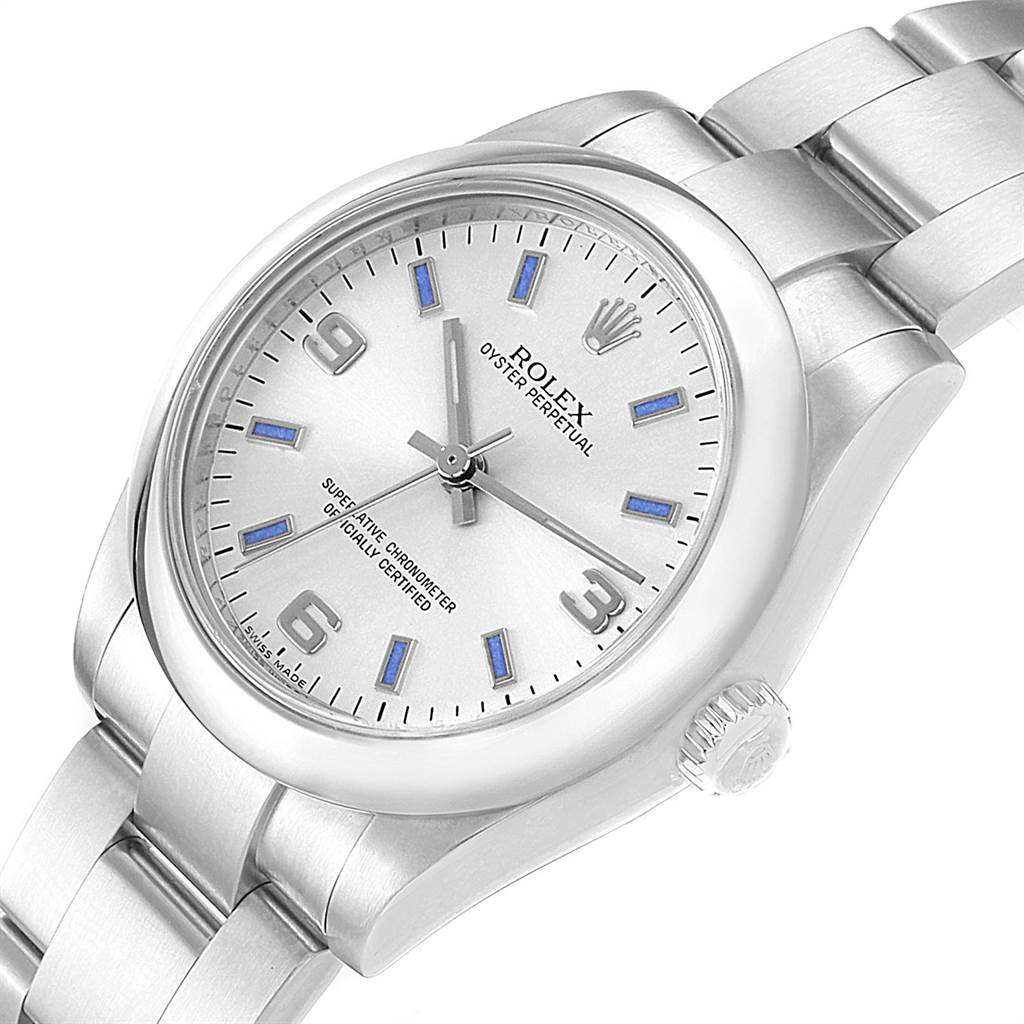 This image shows a silver Rolex Oyster Perpetual Mid-Size watch from an angled top view, displaying the dial, crown, and part of the bracelet.