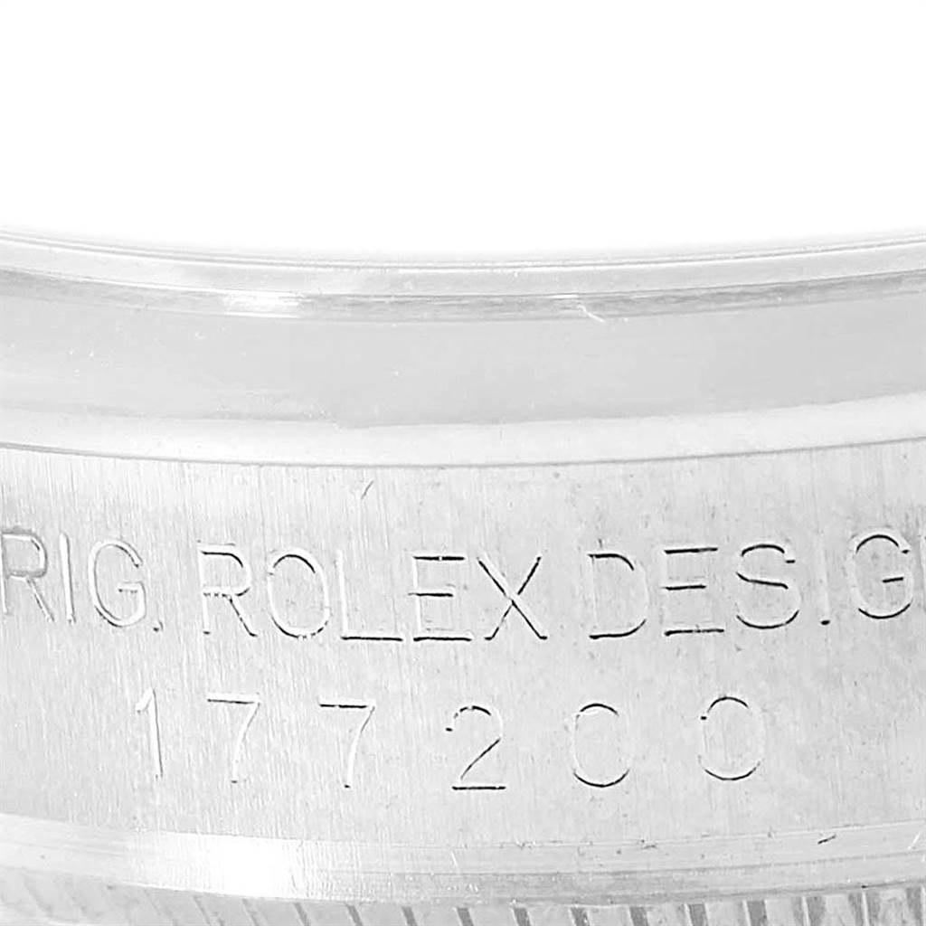 Close-up of the engraved serial number and branding on the side case of a Mid-Size Rolex watch.