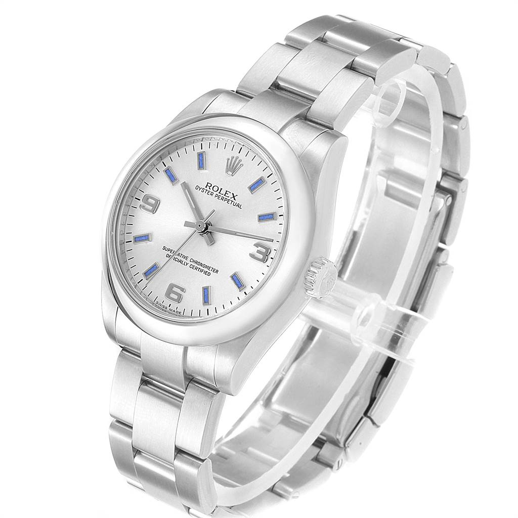 The image shows a Rolex Oyster Perpetual Mid-Size watch at a slight angle, displaying the face, bezel, crown, and bracelet.