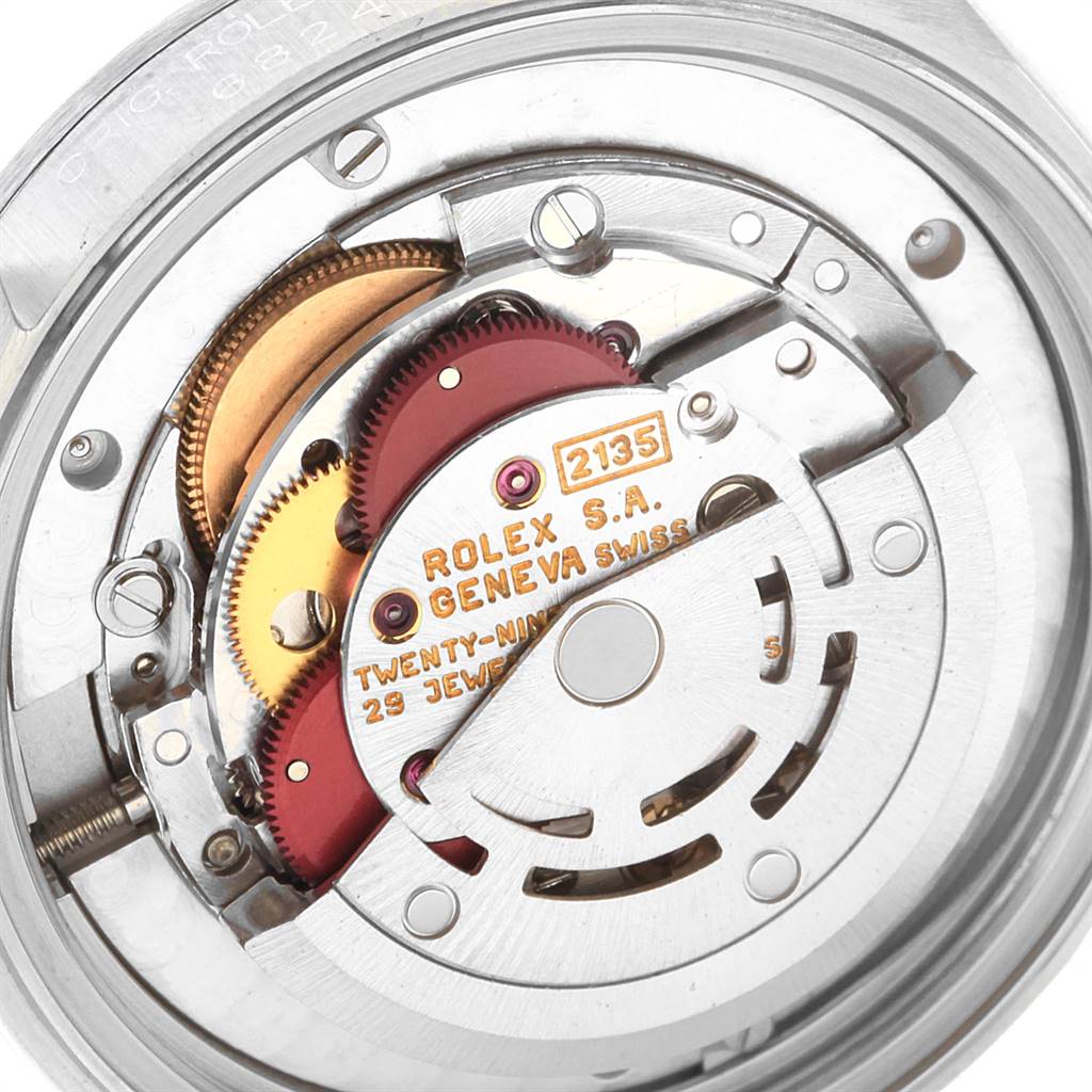 The image shows the internal mechanism of a Rolex Mid-Size 68240 Women's Stainless Steel Black Dial 68240 Women's Stainless Steel Black Dial watch, including gears and the rotor.