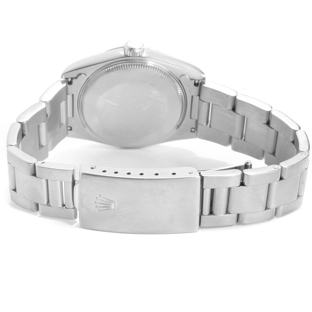 This image shows the back and clasp of the Mid-Size Rolex watch, highlighting its stainless steel bracelet and caseback.