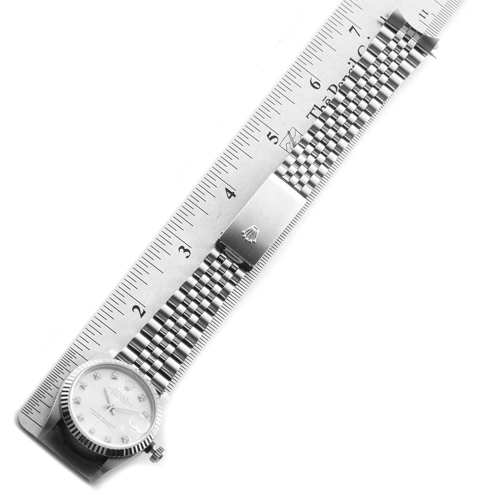 The image shows the Rolex Mid-Size 68274 Women's Stainless Steel Silver Dial 68274 Women's Stainless Steel Silver Dial watch laid flat next to a ruler, highlighting the case, dial, and bracelet clasp.