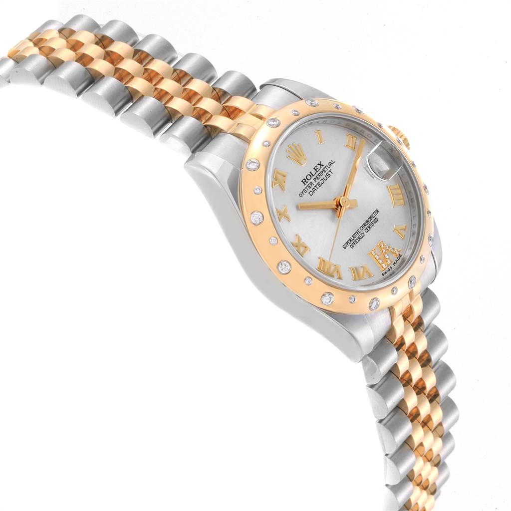 The image shows a Mid-Size Rolex Datejust from a side angle, highlighting its dial, bezel, crown, and two-tone bracelet.