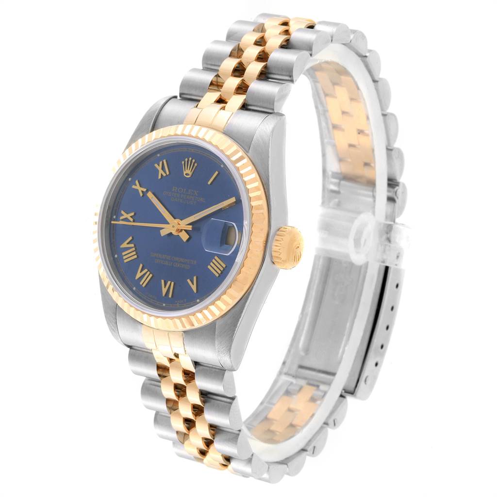 The Rolex Mid-Size 68273 Women's Steel and Gold (two tone) Blue Dial 68273 Women's Steel and Gold (two tone) Blue Dial model is shown from a three-quarter angle, highlighting the blue dial, gold bezel, crown, and two-tone bracelet.