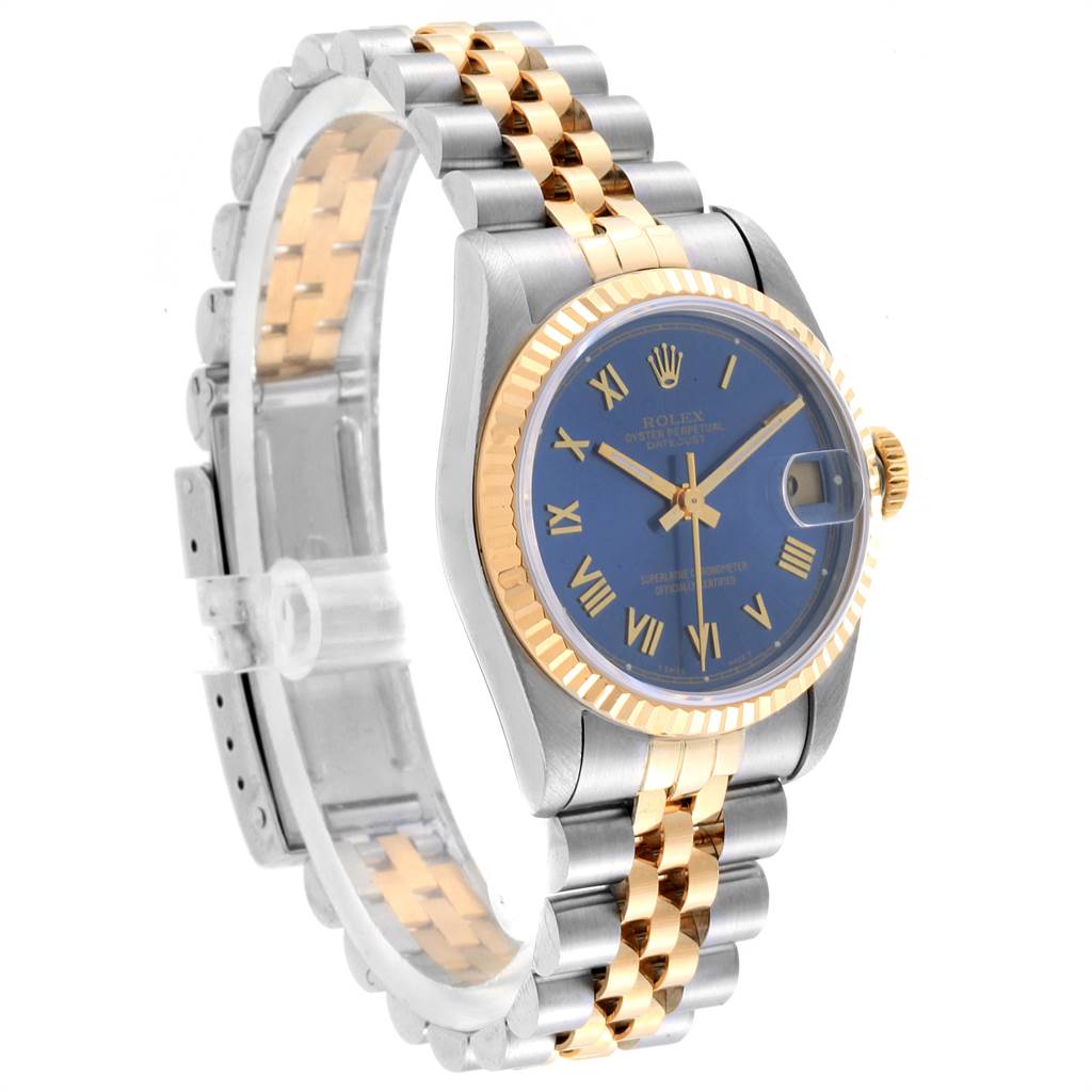 The image shows the front and side view of a mid-size Rolex watch with a blue dial, two-tone bracelet, and fluted bezel.