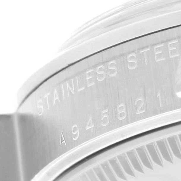 The image shows the engraved serial number and "Stainless Steel" marking on the side of a Rolex Mid-Size 77080 Women's Stainless Steel Pink Dial 77080 Women's Stainless Steel Pink Dial model watch case.