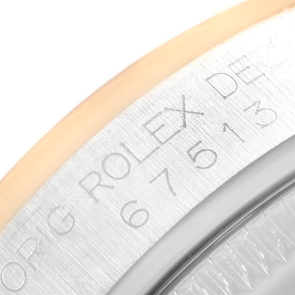 This image shows a close-up of the engraved side of a Rolex Mid-Size 67513 Women's Steel and Gold (two tone) White Dial 67513 Women's Steel and Gold (two tone) White Dial watch case.