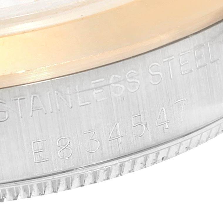 This close-up image shows the case side with serial engraving on a Rolex Mid-Size 67513 Women's Steel and Gold (two tone) White Dial 67513 Women's Steel and Gold (two tone) White Dial watch.