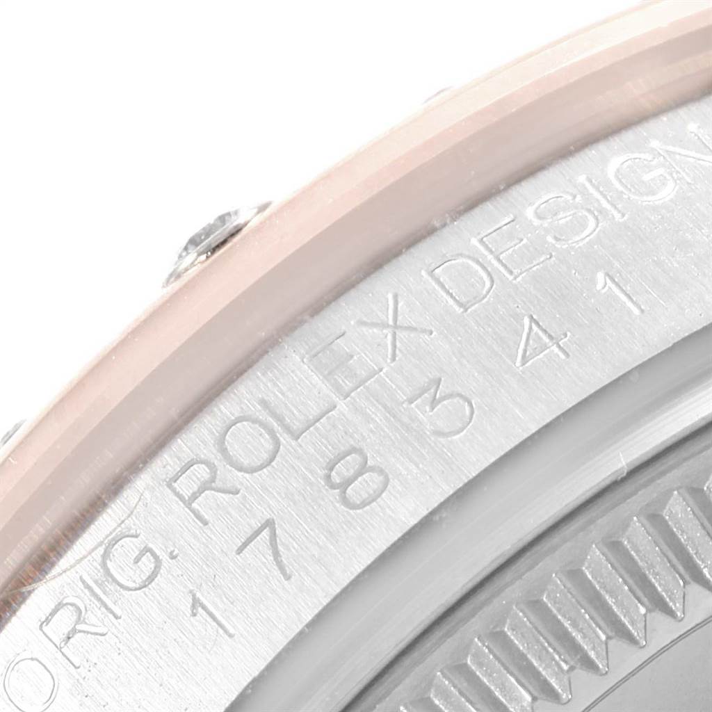 This image shows a close-up of the case and edge of the bezel of a Mid-Size Rolex watch.