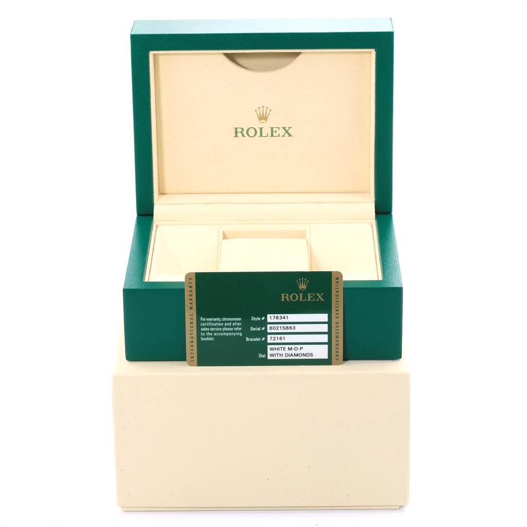 The image shows an open box for a mid-size Rolex watch with the brand and model certificate card displayed in front.