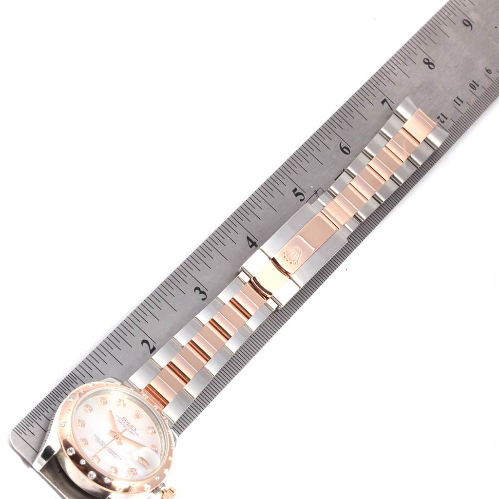 The image displays a partial front view of a Rolex Mid-Size 178341 Women's Steel and Gold (two tone) Mother of Pearl Dial 178341 Women's Steel and Gold (two tone) Mother of Pearl Dial model watch, showing the face and bracelet alongside a ruler for scale.