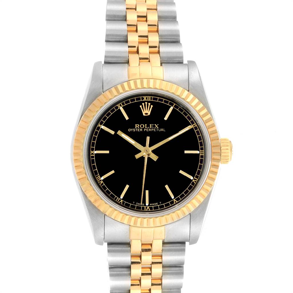 The image shows a front view of a Rolex Oyster Perpetual Mid-Size watch with a black dial, gold bezel, and a two-tone metal strap.