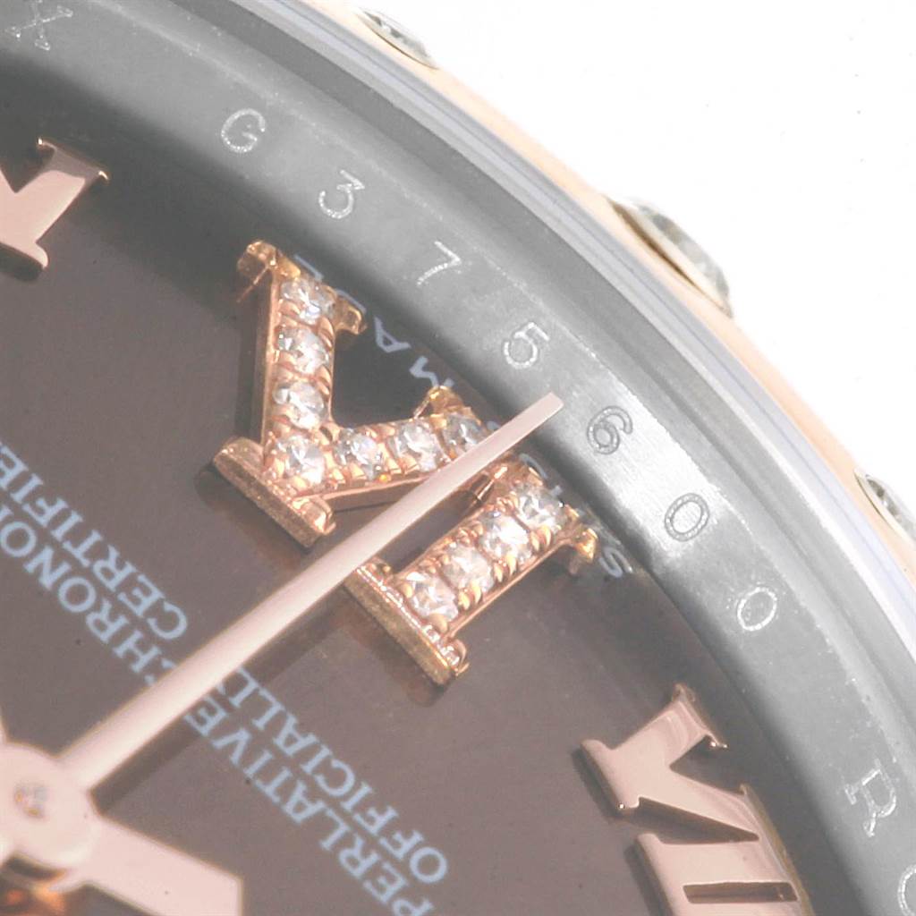 This close-up angle of a Rolex Mid-Size 178341 Women's Steel and Gold (two tone) Brown Dial 178341 Women's Steel and Gold (two tone) Brown Dial watch shows the bezel, partial dial, and a diamond-studded numeral 'VI.'