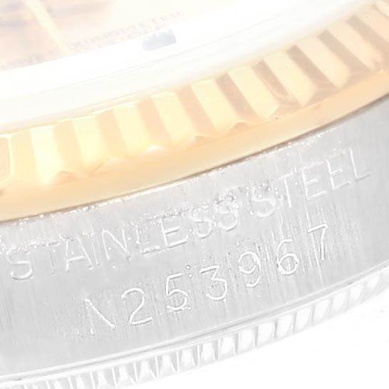 The image shows a close-up of the serial number and stainless steel marking on the bezel of a Rolex Mid-Size 68273 Women's Steel and Gold (two tone) Silver Dial 68273 Women's Steel and Gold (two tone) Silver Dial model watch.