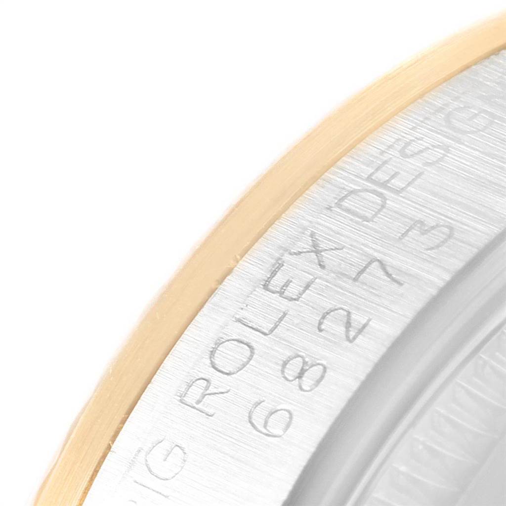 The image shows a close-up of the bezel and engraved inner rim of the Mid-Size Rolex watch.