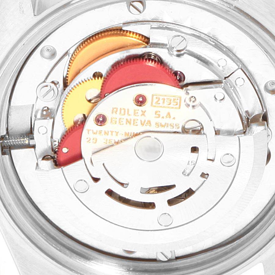 The image shows the internal mechanical movement of a Rolex Mid-Size 68273 Women's Steel and Gold (two tone) Silver Dial 68273 Women's Steel and Gold (two tone) Silver Dial watch, showcasing gears, screws, and the rotor.
