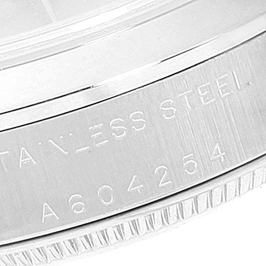 The image shows a close-up of the case back of a Rolex Mid-Size 77080 Women's Stainless Steel Pink Dial 77080 Women's Stainless Steel Pink Dial model, highlighting the stainless steel material and serial number.