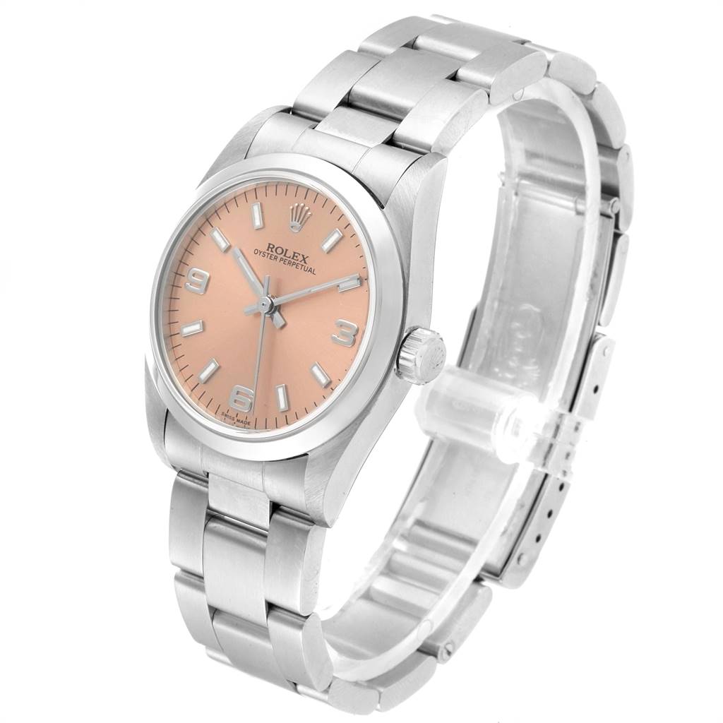 The Rolex Mid-Size 77080 Women's Stainless Steel Pink Dial 77080 Women's Stainless Steel Pink Dial Oyster Perpetual watch is shown at a three-quarter angle, highlighting the bracelet, crown, and face with a pink dial.