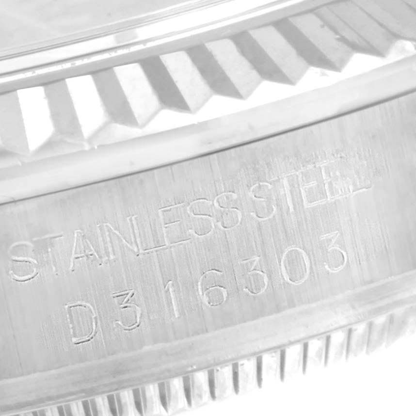 This close-up image shows the serial number and part of the bezel of a Rolex Mid-Size 178274 Women's Stainless Steel Blue Dial 178274 Women's Stainless Steel Blue Dial model watch.