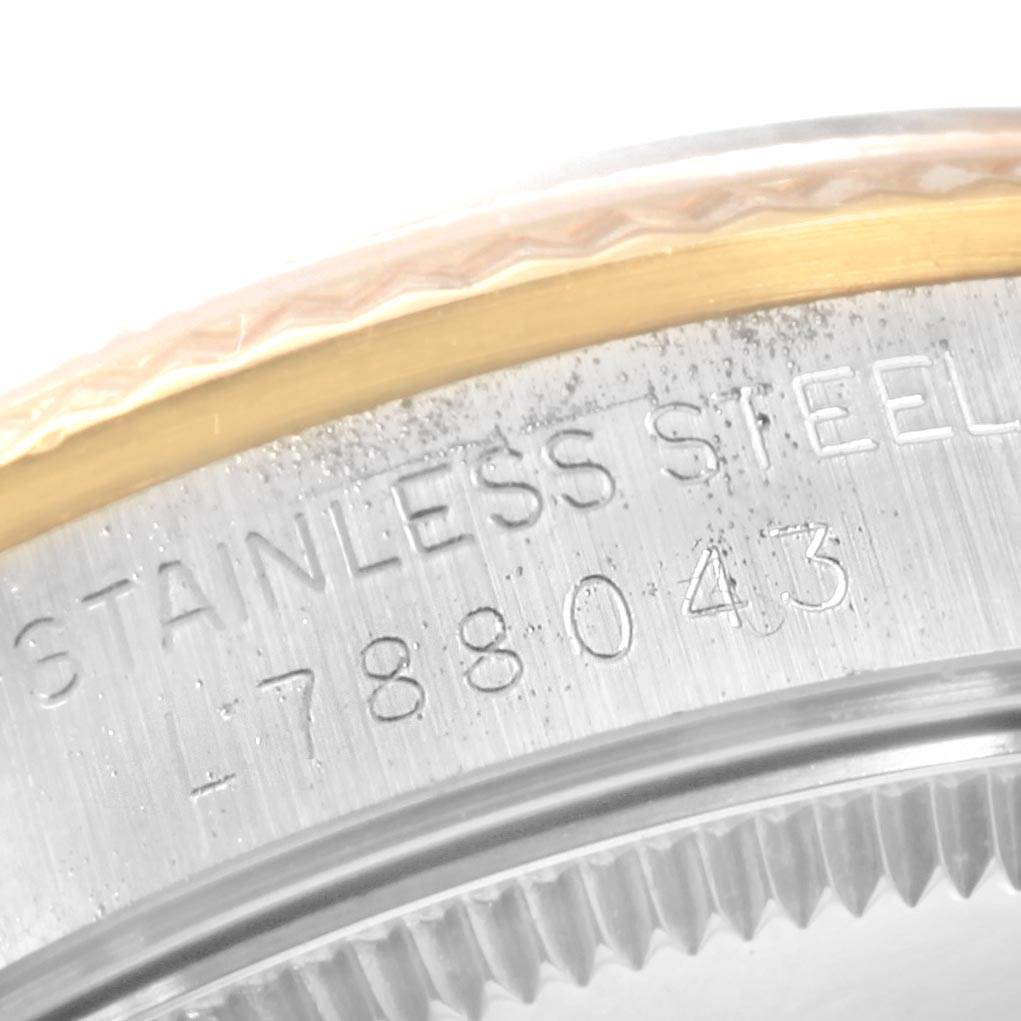 The image shows a close-up angle of the stainless steel case back of a Mid-Size Rolex watch, highlighting the model number.