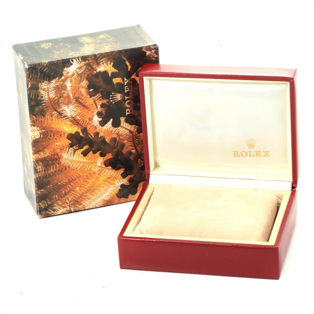 This image shows a Rolex Mid-Size 68273 Women's Steel and Gold (two tone) Champagne Dial 68273 Women's Steel and Gold (two tone) Champagne Dial model watch box and its decorative outer box at a slight angle.