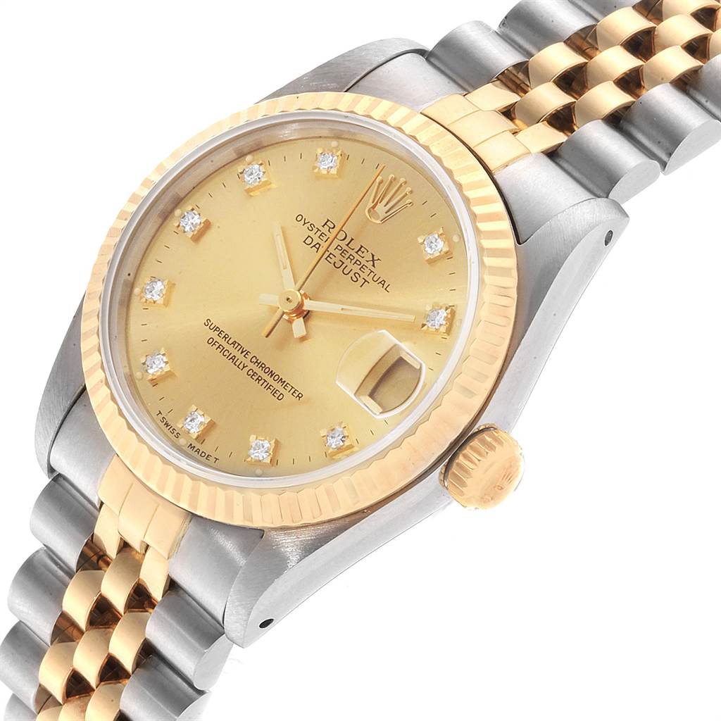 This image shows the face, crown, and part of the bracelet of a Rolex Mid-Size 68273 Women's Steel and Gold (two tone) Champagne Dial 68273 Women's Steel and Gold (two tone) Champagne Dial Oyster Perpetual Datejust watch at an angle.