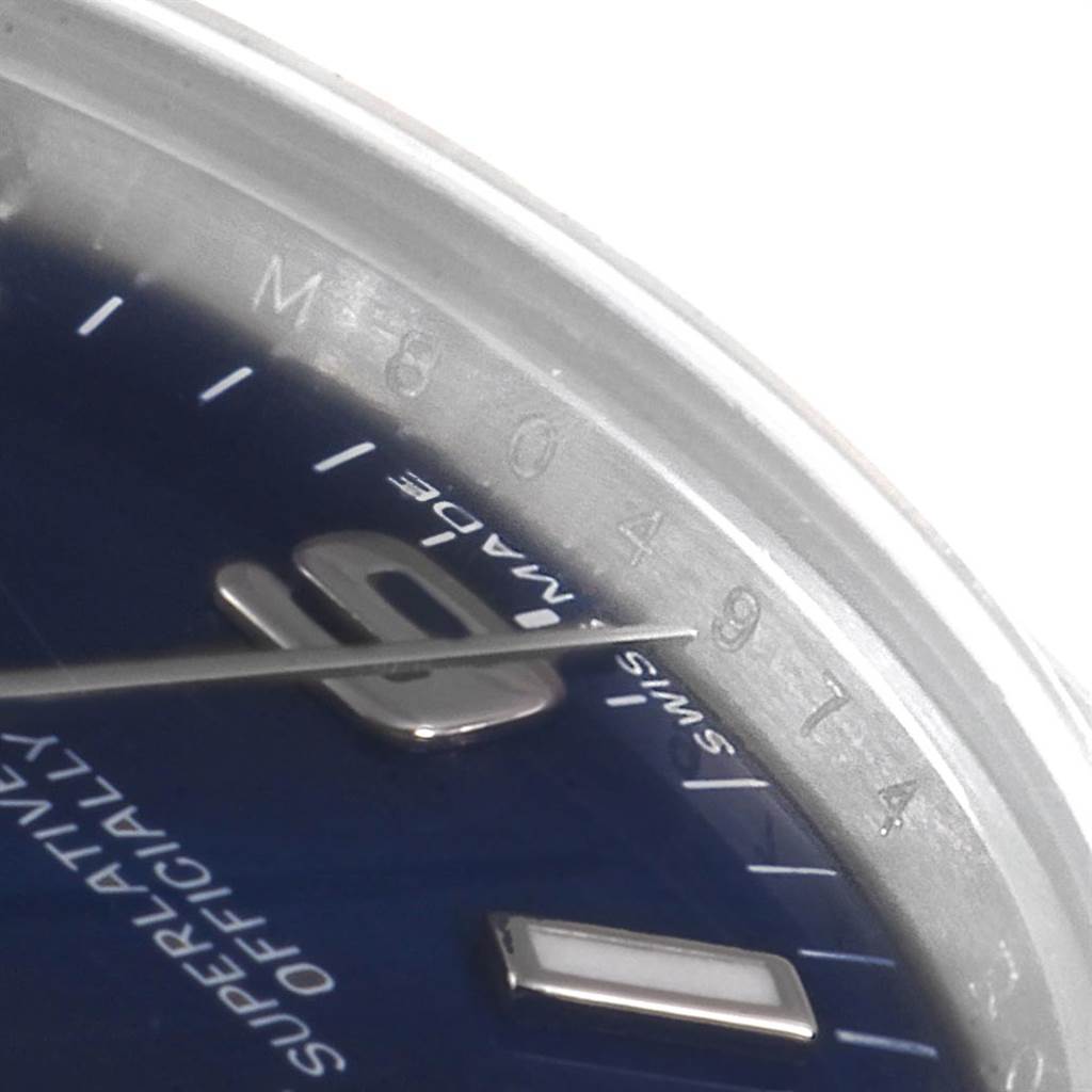 The image shows a close-up angle of the Rolex Mid-Size 177234 Women's Stainless Steel Blue Dial 177234 Women's Stainless Steel Blue Dial model watch, focusing on part of the dial, hands, and serial number on the inner bezel.