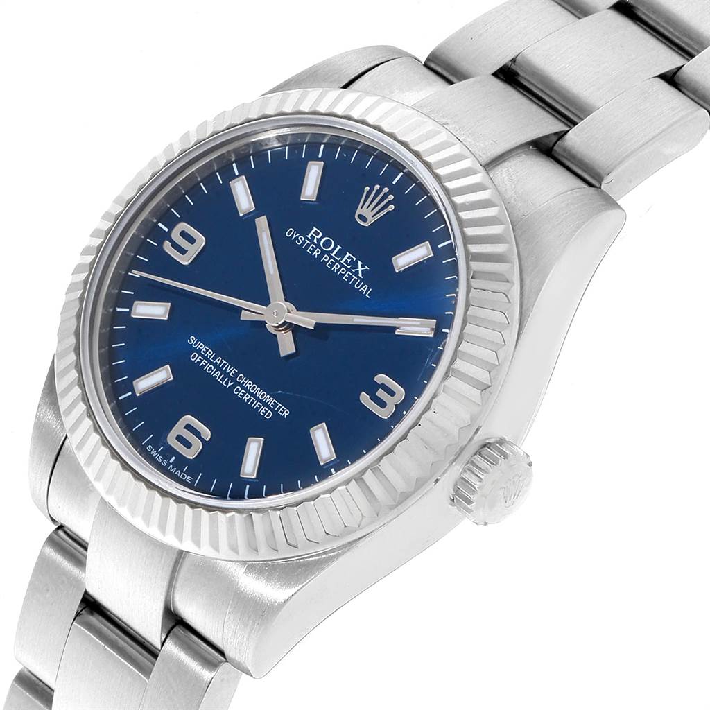The Rolex Oyster Perpetual Mid-Size watch is shown at a slight left angle, displaying its dial, crown, and part of the bracelet.