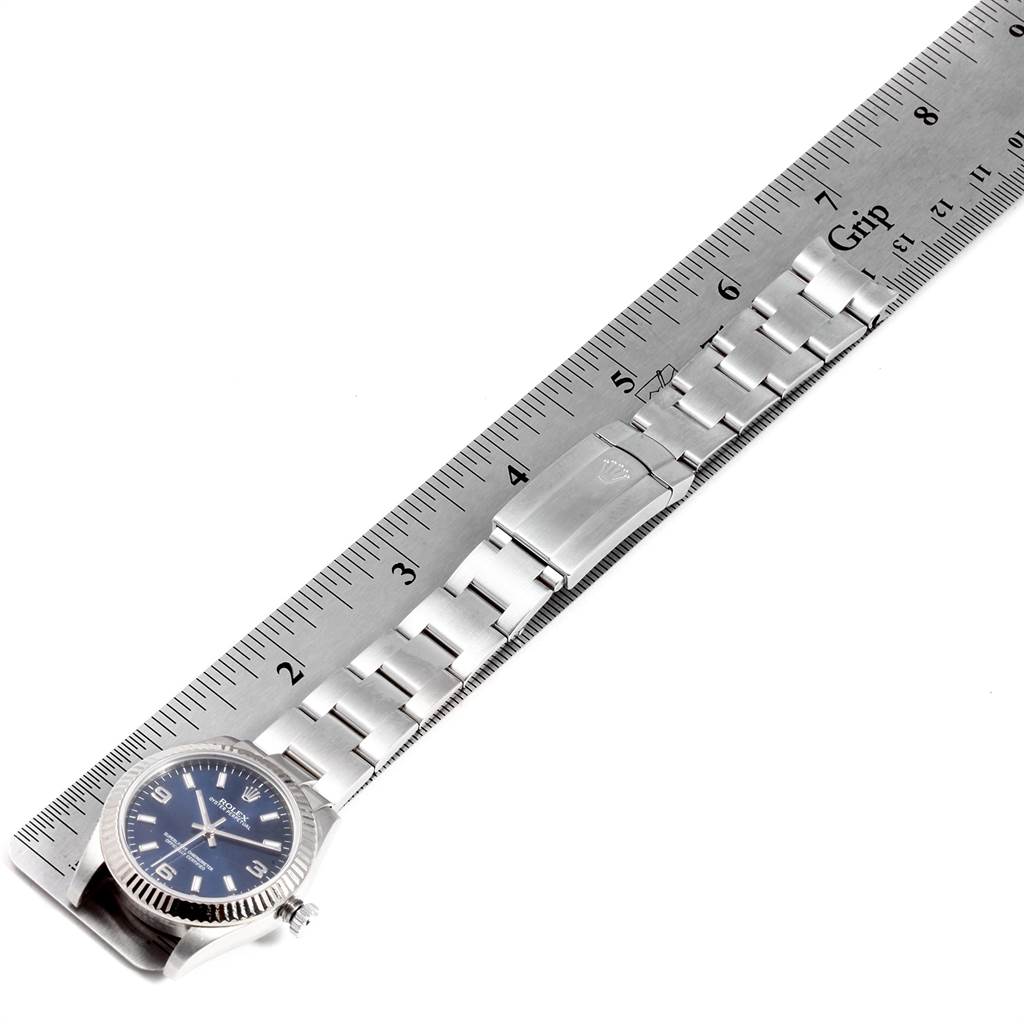 The Rolex Mid-Size 177234 Women's Stainless Steel Blue Dial 177234 Women's Stainless Steel Blue Dial model watch is shown flat, with a close-up view of its bracelet next to a ruler.