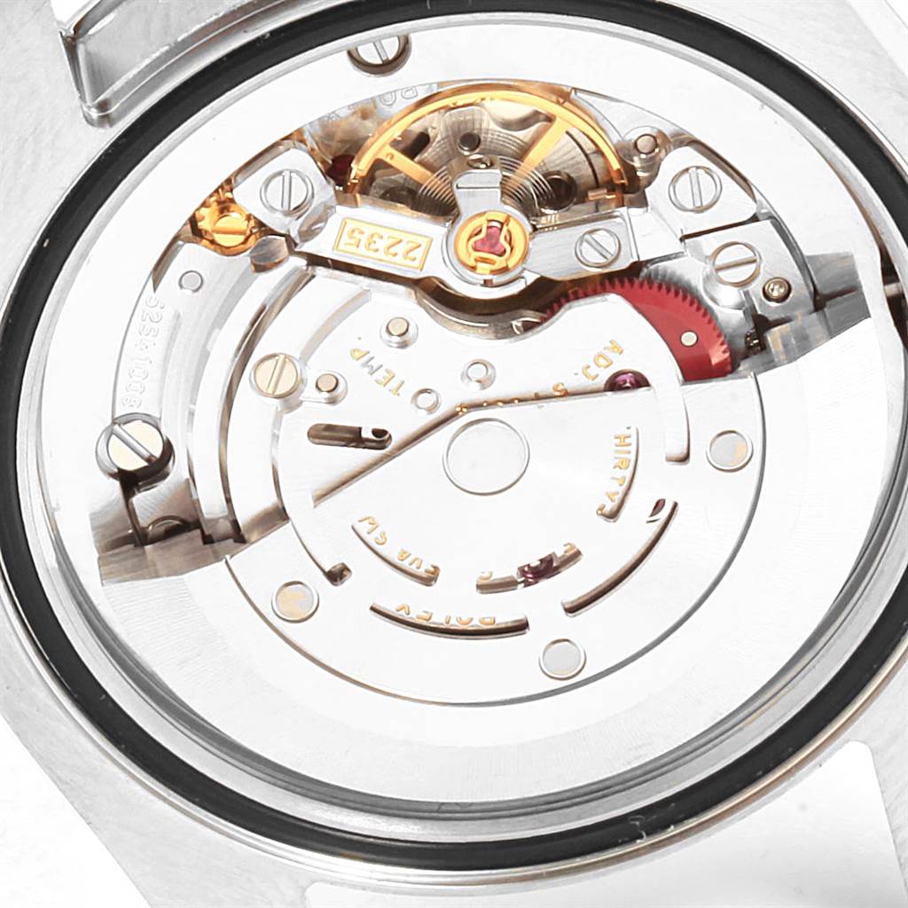 The image shows a close-up view of the movement mechanism of a Mid-Size Rolex watch.
