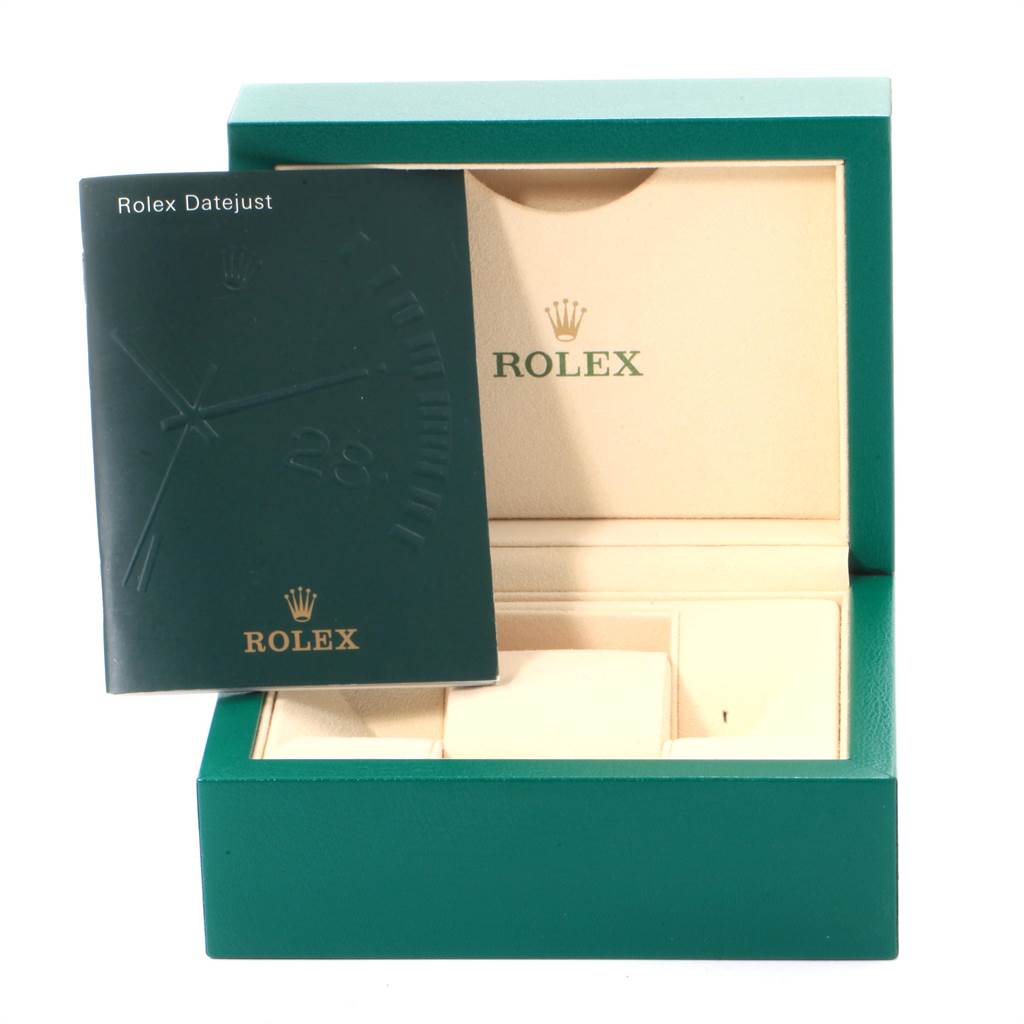 This image shows a green Rolex Datejust box with an open manual placed in front of it.
