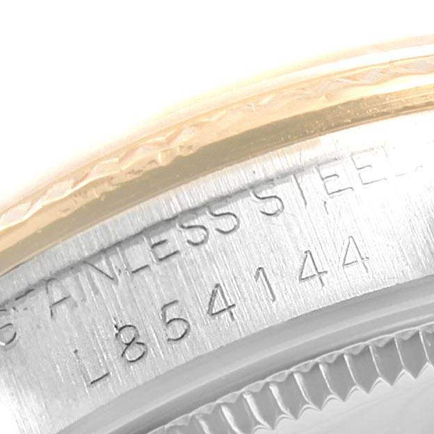 This is a close-up angle of the serial number and stainless steel inscription on the side of a Rolex Mid-Size 68273 Women's Steel and Gold (two tone) Champagne Dial 68273 Women's Steel and Gold (two tone) Champagne Dial watch case.