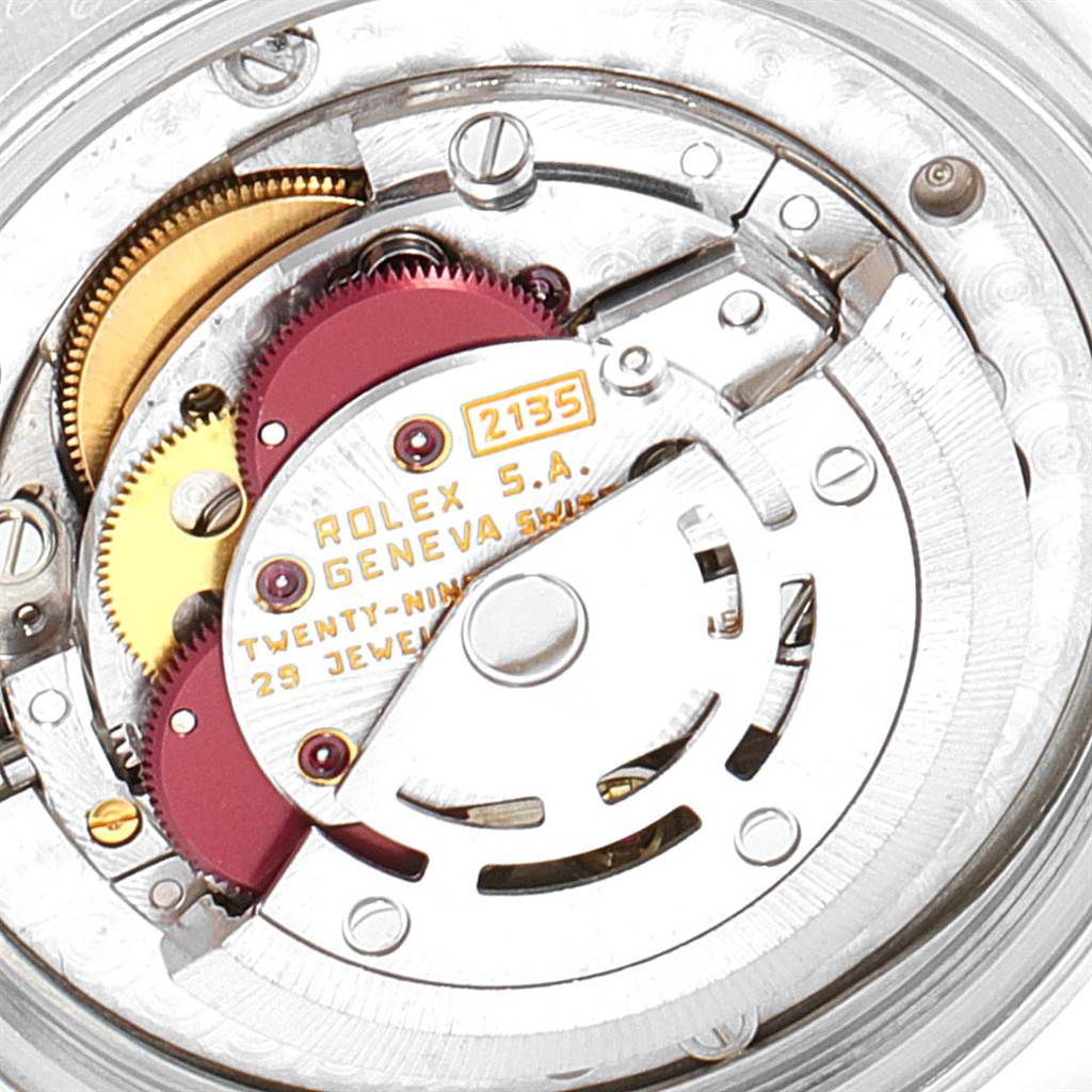 The image shows the intricate internal mechanism of a mid-size Rolex watch, focusing on its gears and rotor.