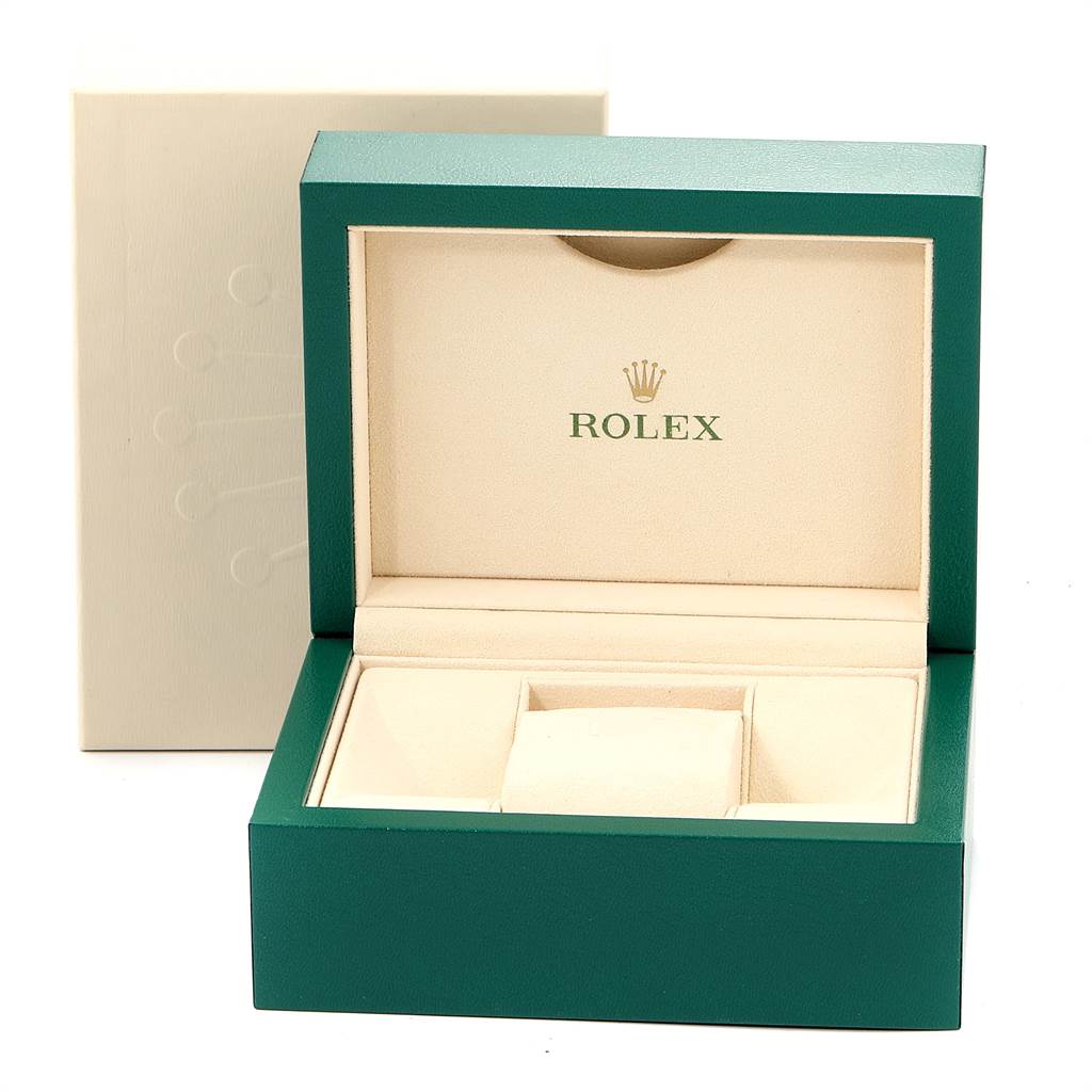 The image shows an open Rolex watch box at a slight angle, highlighting its green exterior and beige interior.