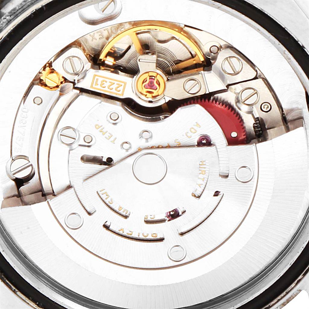 The image shows the interior mechanical movement of a Mid-Size Rolex watch, viewed from a top-down angle.