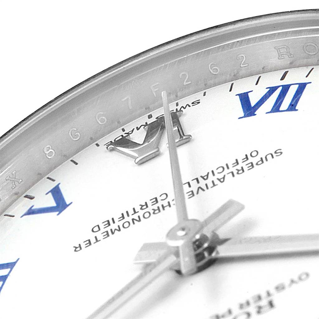 The image shows a close-up of the dial and hands of a Mid-Size Rolex watch, highlighting the Roman numeral markers and official certification text.