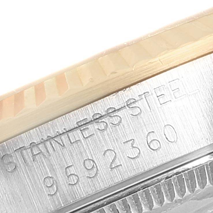 This close-up image shows the side engraving and beveled edge of a stainless steel Rolex Mid-Size 68273 Women's Steel and Gold (two tone) Beige Dial 68273 Women's Steel and Gold (two tone) Beige Dial watch.