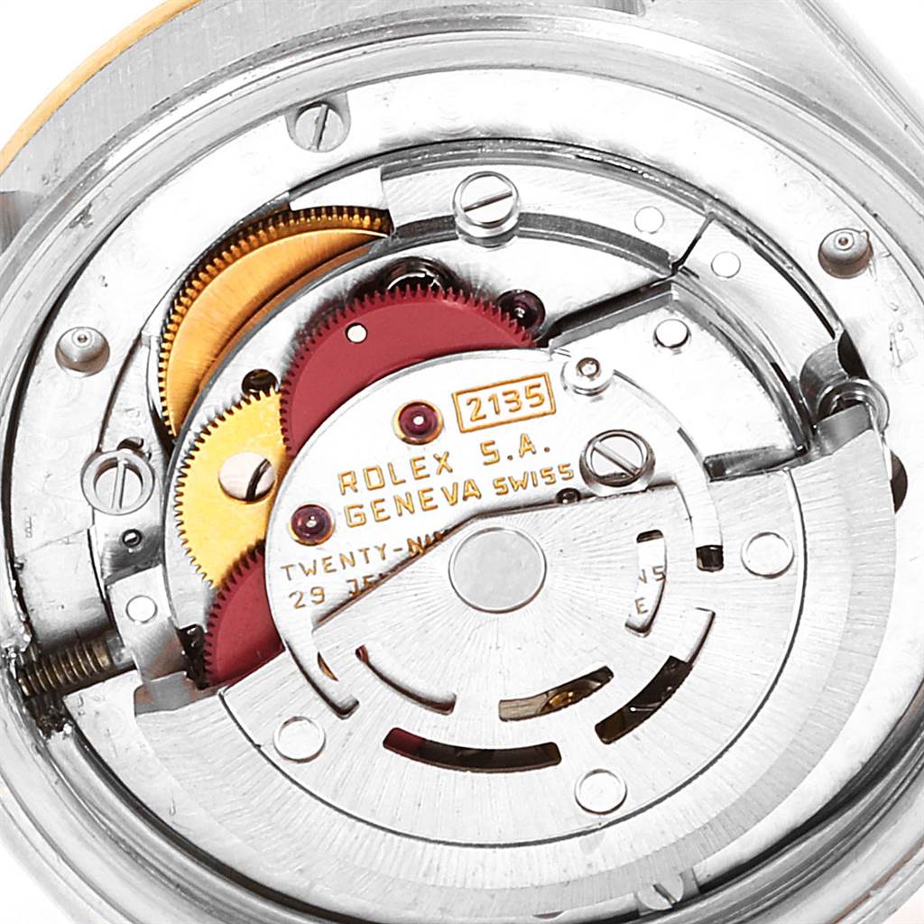 The image shows a detailed view of the movement of a Rolex Mid-Size 68273 Women's Steel and Gold (two tone) Silver Dial 68273 Women's Steel and Gold (two tone) Silver Dial model watch, focusing on the internal gears and components.