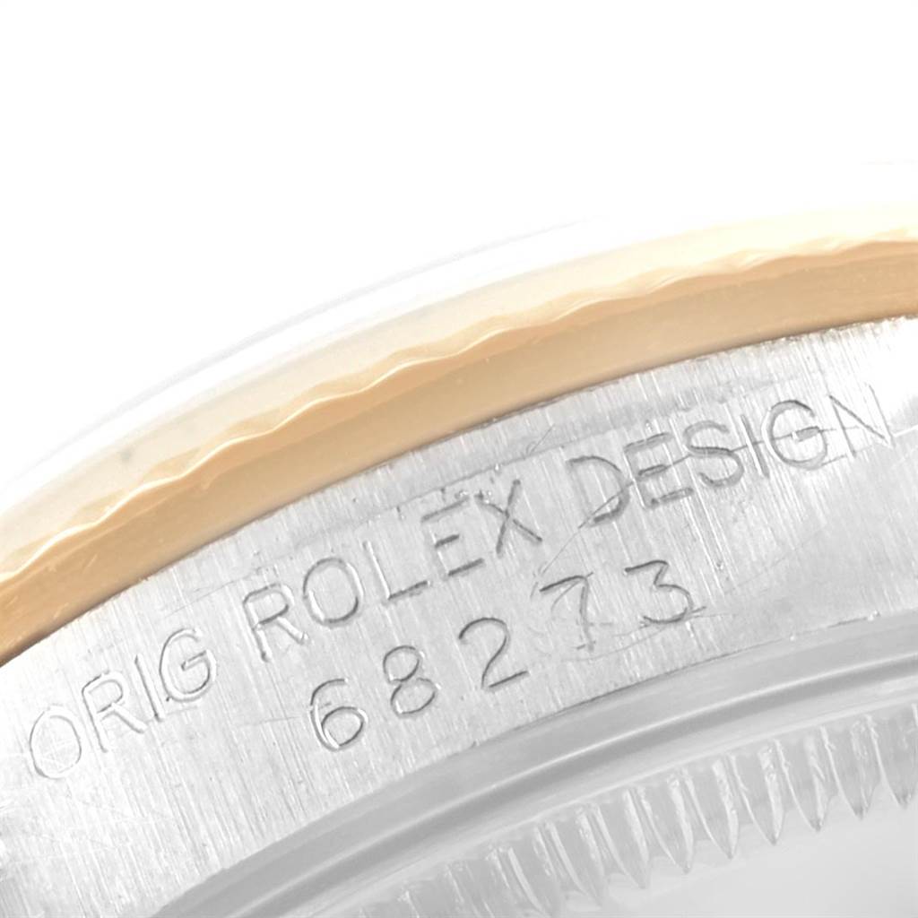 This image shows a close-up of the case back of a Mid-Size Rolex watch, highlighting the engraved model number and the Rolex brand.