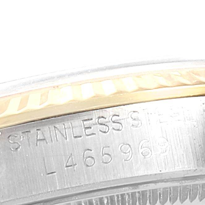 This close-up image shows part of the stainless steel case and bezel of a Rolex Mid-Size 67513 Women's Steel and Gold (two tone) Champagne Dial 67513 Women's Steel and Gold (two tone) Champagne Dial model watch, highlighting its serial number.