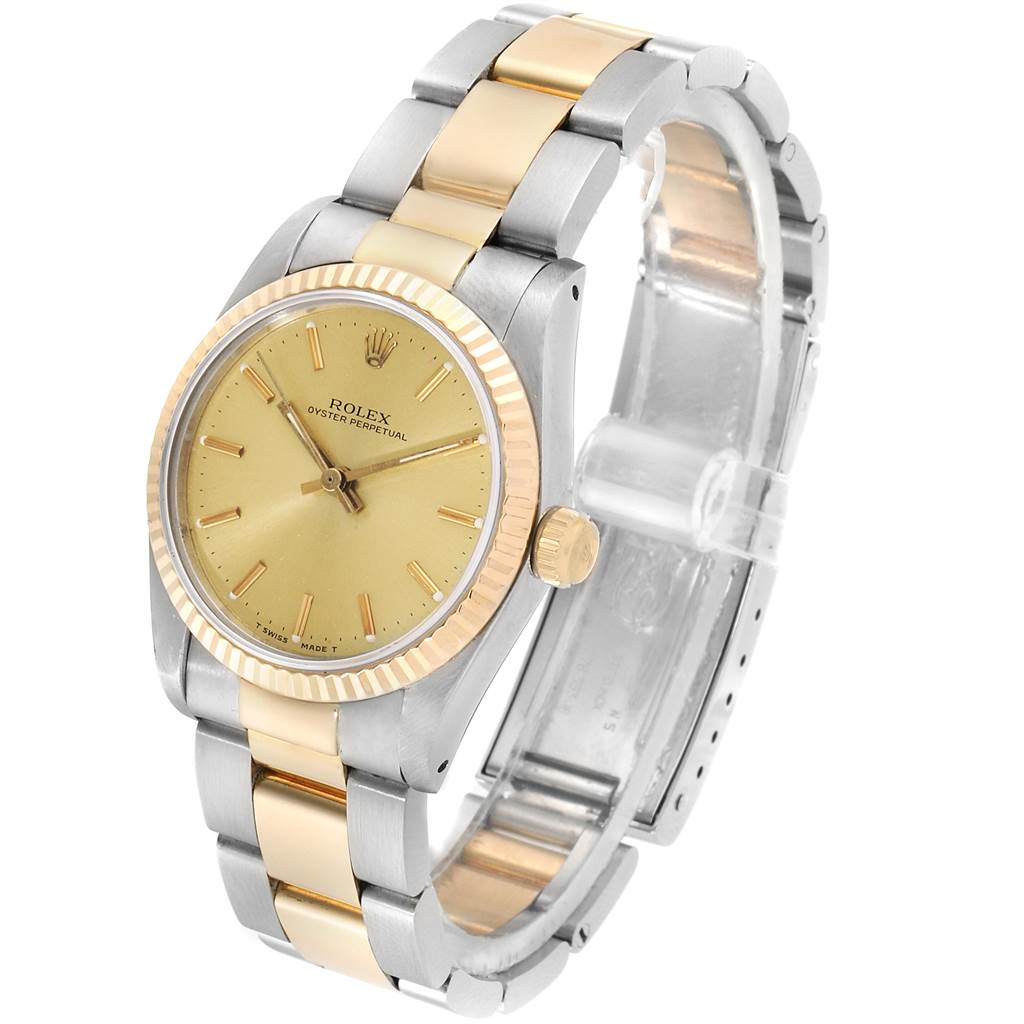The Rolex Mid-Size 67513 Women's Steel and Gold (two tone) Champagne Dial 67513 Women's Steel and Gold (two tone) Champagne Dial watch is shown at an angle highlighting its gold and silver band, face, crown, and fluted bezel.