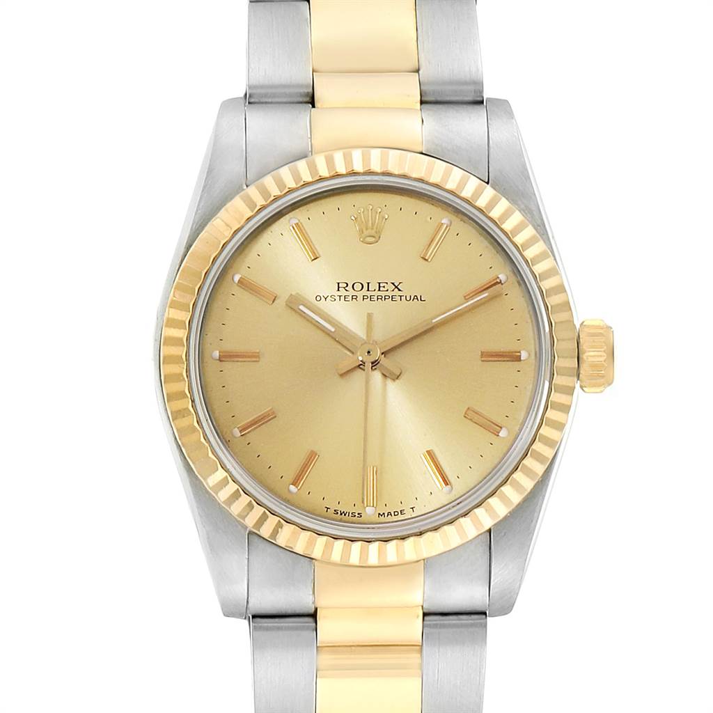 The image shows a front view of a Rolex Mid-Size 67513 Women's Steel and Gold (two tone) Champagne Dial 67513 Women's Steel and Gold (two tone) Champagne Dial Oyster Perpetual watch, displaying its dial, bezel, and bracelet.