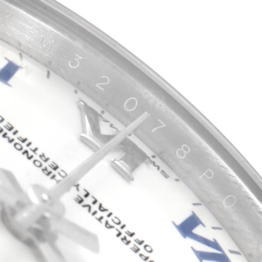 This close-up of a Mid-Size Rolex watch focuses on the edge of the dial, showing the hour markers and part of the hour hand.