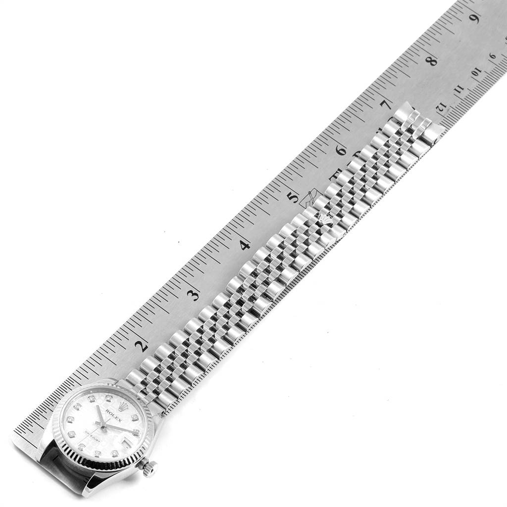 The image shows a Rolex Mid-Size 178274 Women's Stainless Steel Silver Dial 178274 Women's Stainless Steel Silver Dial watch laid next to a ruler, highlighting the watch's face and bracelet.