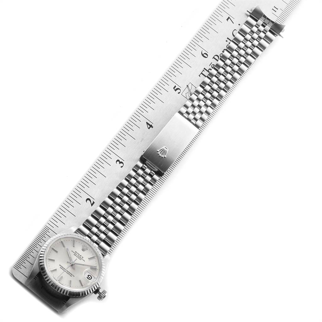 The image shows a Rolex Mid-Size 68274 Women's Stainless Steel Silver Dial 68274 Women's Stainless Steel Silver Dial watch laid flat next to a ruler, displaying the watch face, bracelet, and clasp.